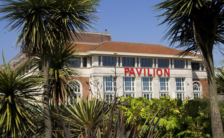 The Pavilion Theatre surrounded by palm trees